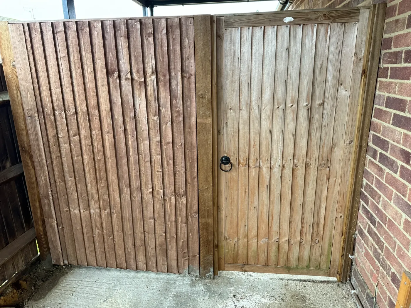Repaired closeboard fencing with capping rail