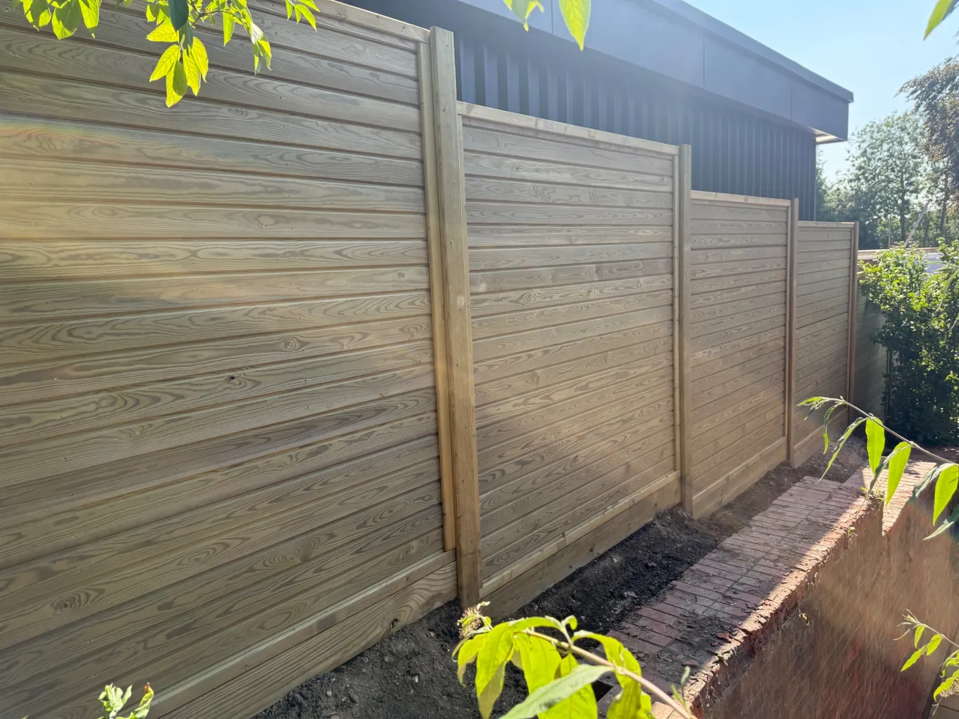 Horizontal tongue and groove fence panels installed in a residential garden