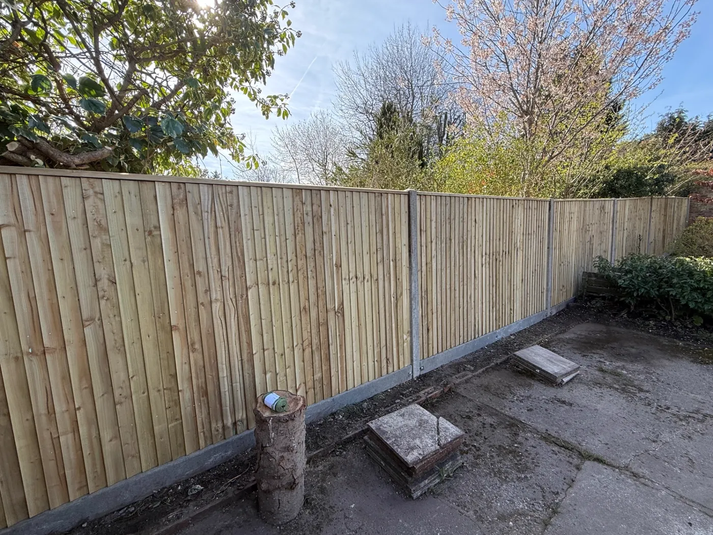 Feather edge closeboard fence with concrete posts along a boundary