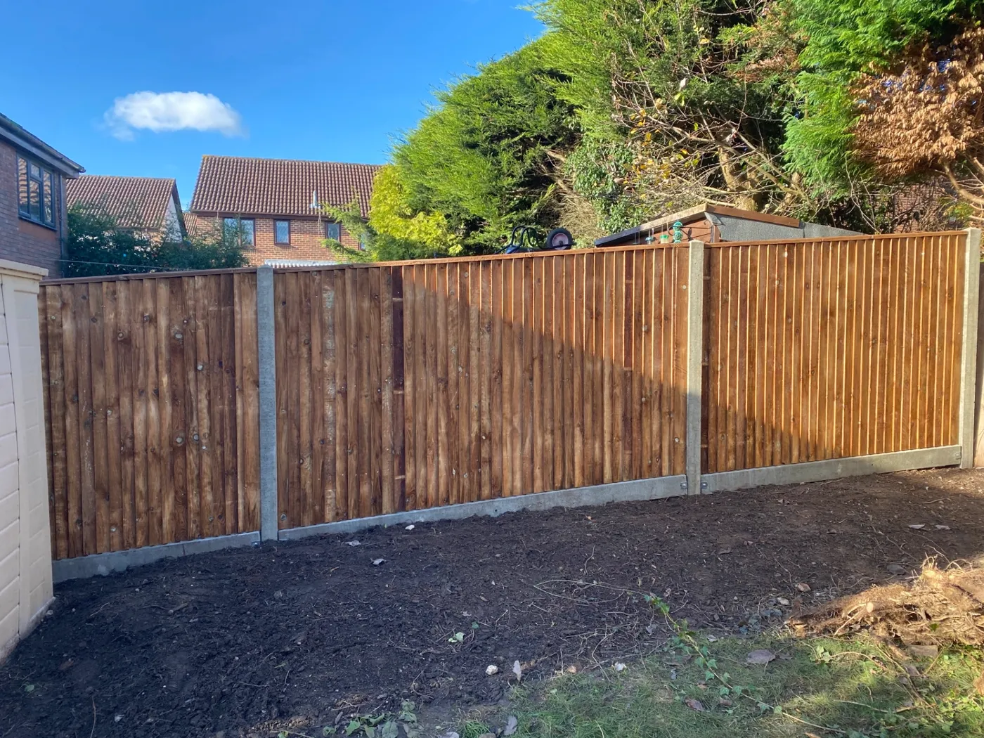 New closeboard fence with concrete posts and gravel boards in a residential garden