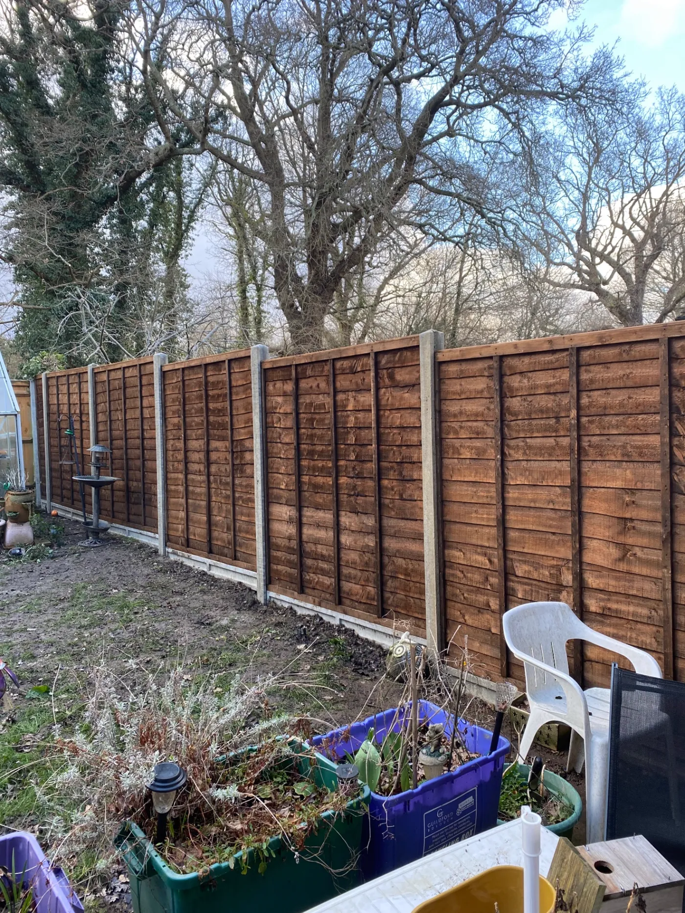 Lap garden fence panels replaced behind a house