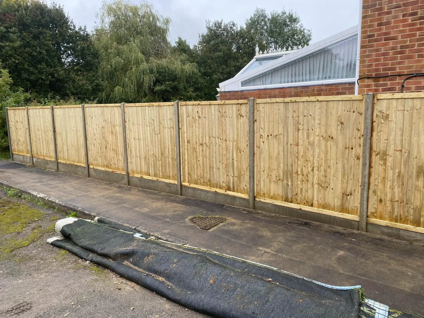 Tongue and groove fence panels fitted along a boundary